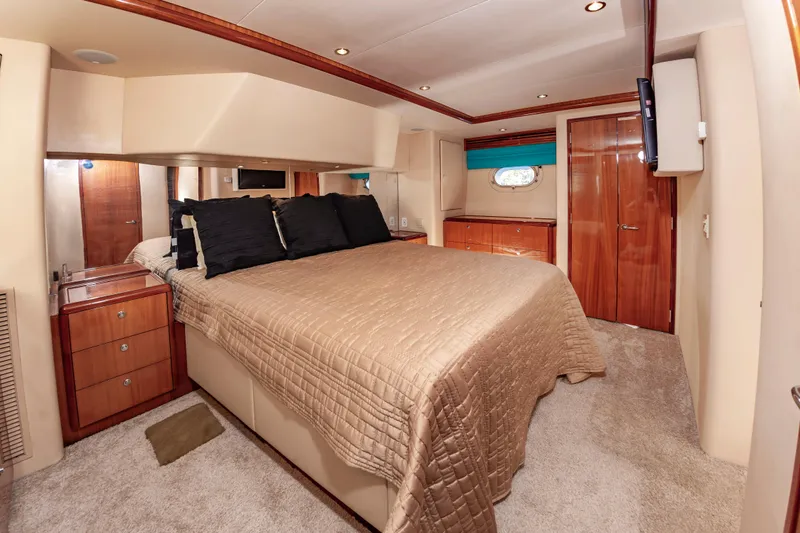 Slide: The Image of Luxurious bedroom interior of 2007 Hatteras 64 Motor Yacht with elegant wood finishes. - 41