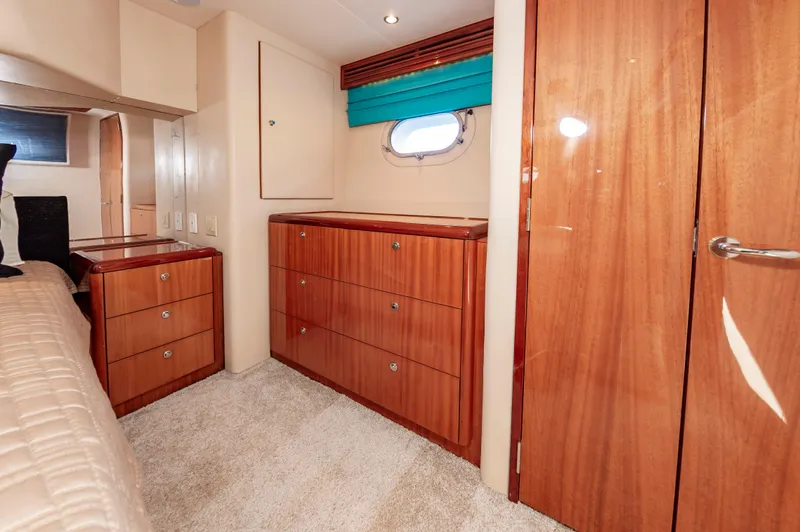 Slide: The Image of Luxurious cabin interior of 2007 Hatteras 64 Motor Yacht with wood cabinetry and porthole. - 44