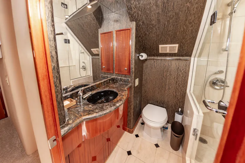 Slide: The Image of Luxurious bathroom in 2007 Hatteras 64 Motor Yacht with granite countertop and modern fixtures. - 46
