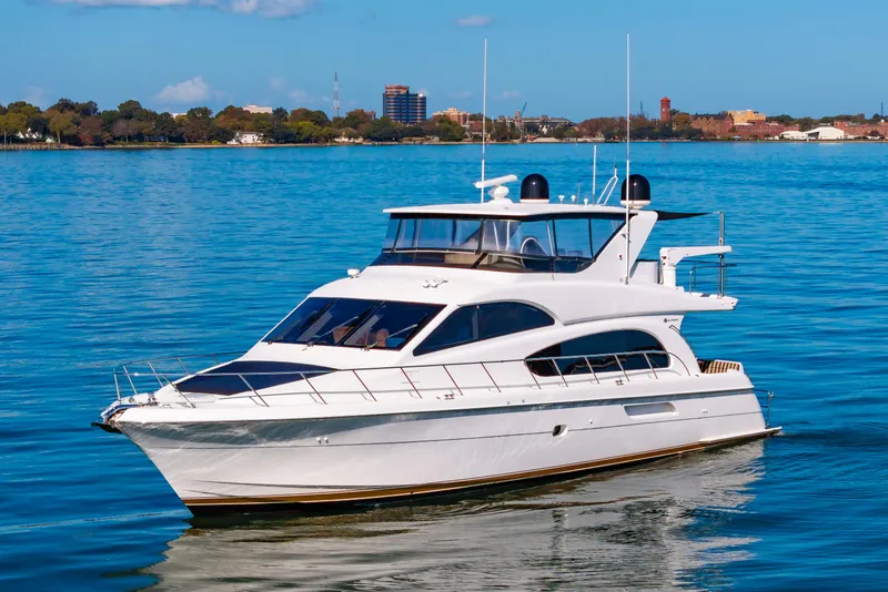 Slide: The Image of 2007 Hatteras 64 Motor Yacht cruising on calm blue waters. - 7