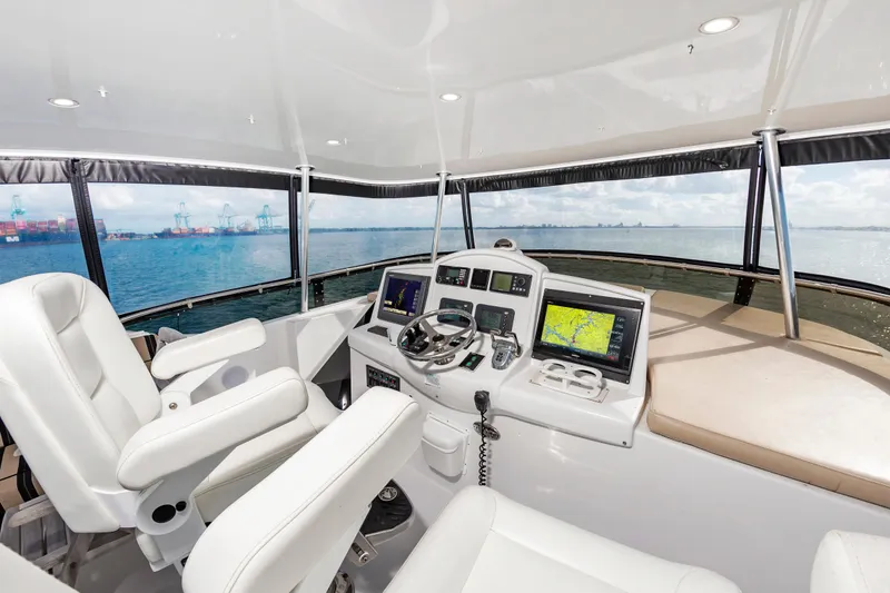 Slide: The Image of Interior helm of 2007 Hatteras 64 Motor Yacht with navigation equipment and ocean view. - 9