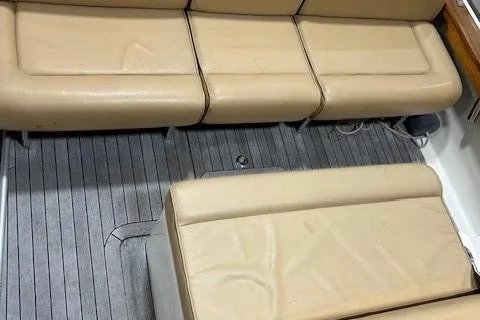 Slide: The Image of 2016 Hunt Yachts Harrier interior with beige seating and gray flooring. - 13