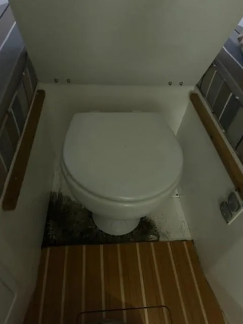 Slide: The Image of 2016 Hunt Yachts Harrier bathroom with wooden flooring and compact toilet. - 4