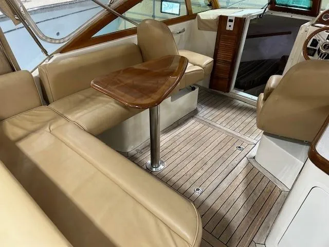 Slide: The Image of 2016 Hunt Yachts Harrier interior with beige seating and wooden table. - 5