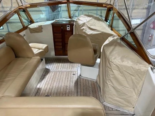 Slide: The Image of 2016 Hunt Yachts Harrier interior with beige seating and wooden accents. - 6