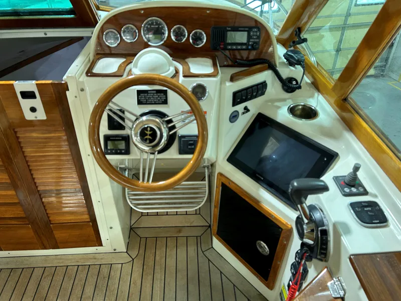 Slide: The Image of 2016 Hunt Yachts Harrier helm with wooden accents and modern navigation equipment. - 7