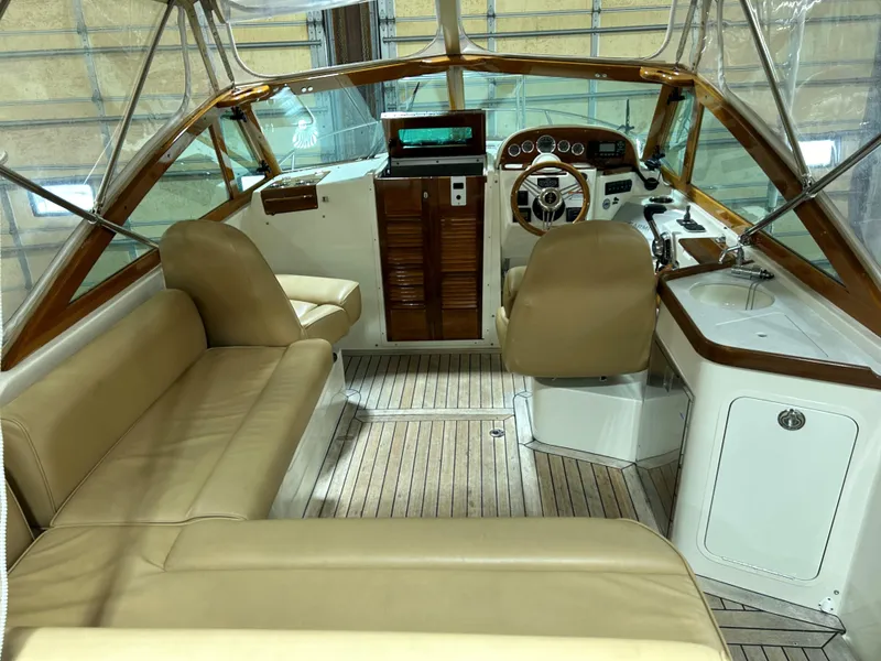 Slide: The Image of 2016 Hunt Yachts Harrier interior with beige seating and wooden accents. - 9