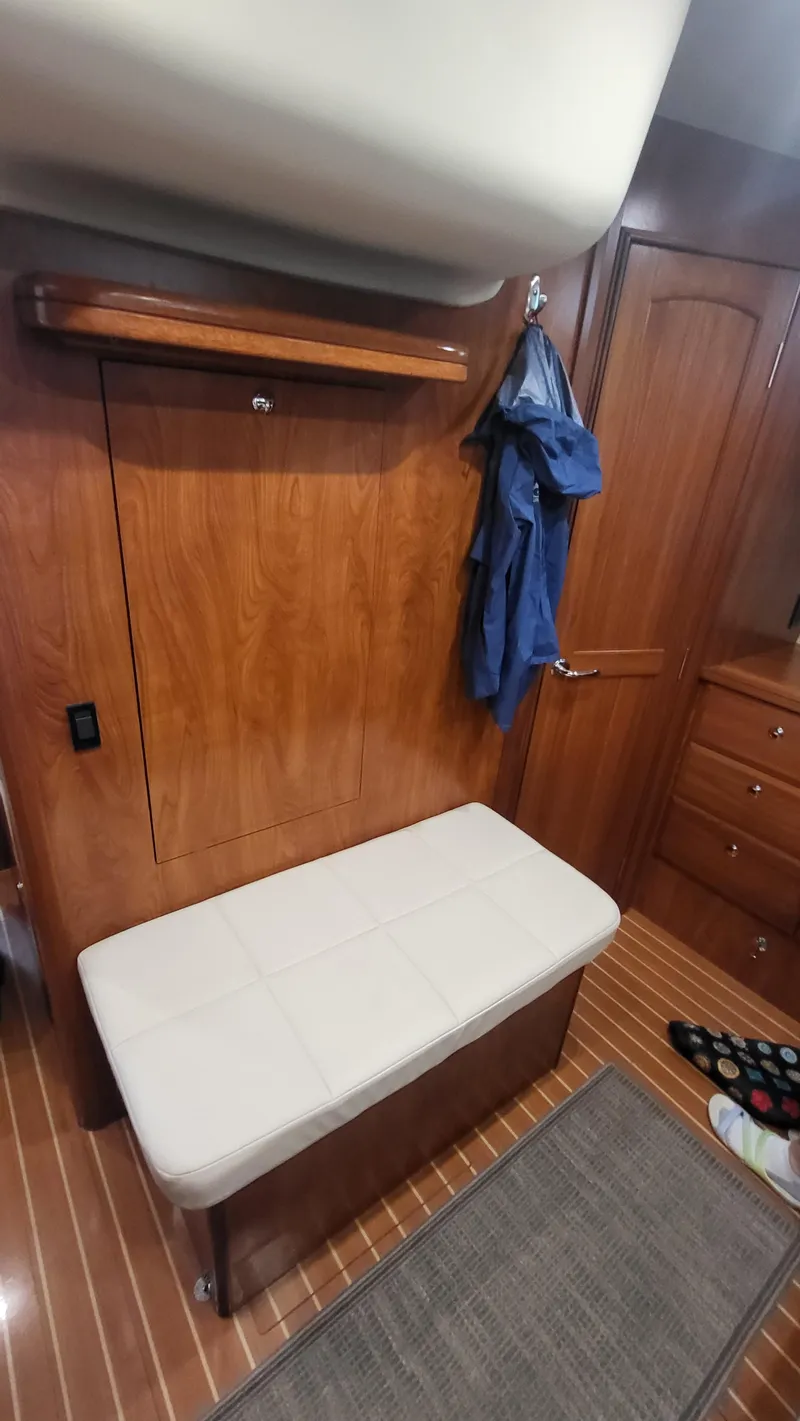 Slide: The Image of Interior of 2009 Hunter 50 CC yacht with wooden paneling and cushioned bench. - 15