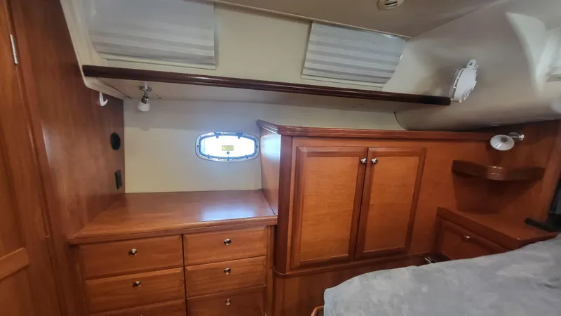 Slide: The Image of 2009 Hunter 50 CC yacht interior with wooden cabinetry and small window. - 35