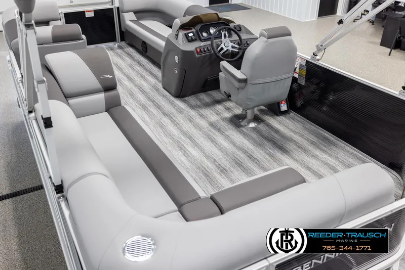 Slide: The Image of 2025 Bennington 21 SLSE pontoon boat interior with gray seating and modern helm. - 11