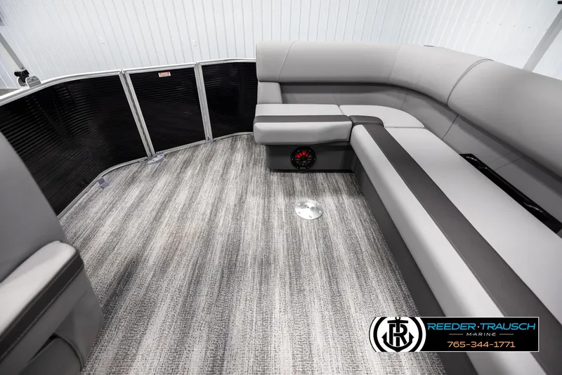 Slide: The Image of Interior of 2025 Bennington 21 SLSE pontoon boat with gray seating and carpet flooring. - 15