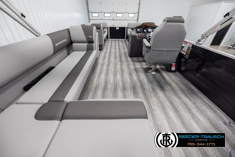 Slide: The Image of 2025 Bennington 21 SLSE pontoon boat interior with gray seating and modern helm. - 16