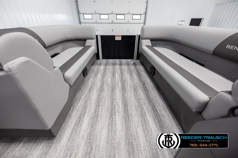 Slide: The Image of Interior of 2025 Bennington 21 SLSE pontoon boat with gray seating and carpet flooring. - 18