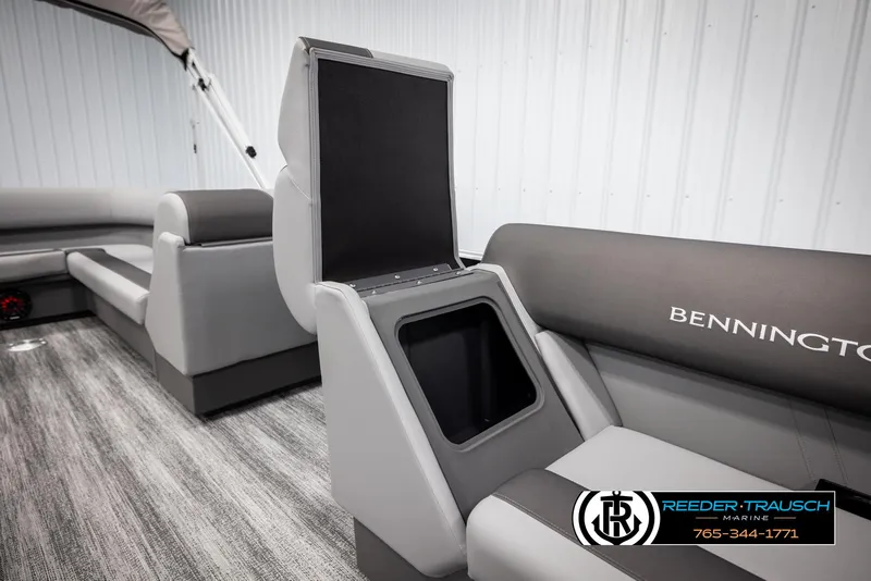 Slide: The Image of 2025 Bennington 21 SLSE pontoon boat interior with open storage compartment and seating. - 21