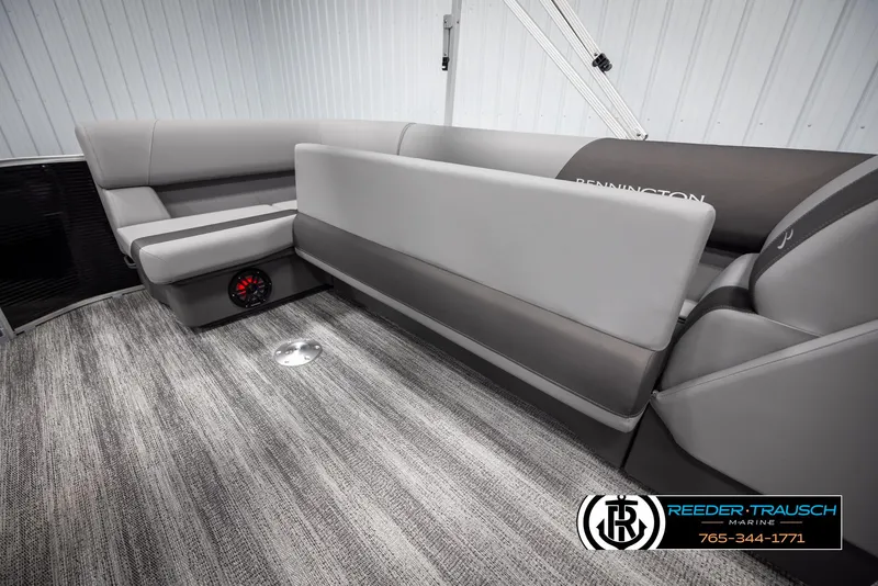 Slide: The Image of 2025 Bennington 21 SLSE pontoon boat interior with gray seating and carpet flooring. - 23