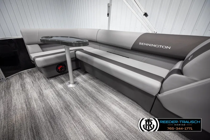 Slide: The Image of Luxurious interior of 2025 Bennington 21 SLSE pontoon boat with sleek seating and table. - 25