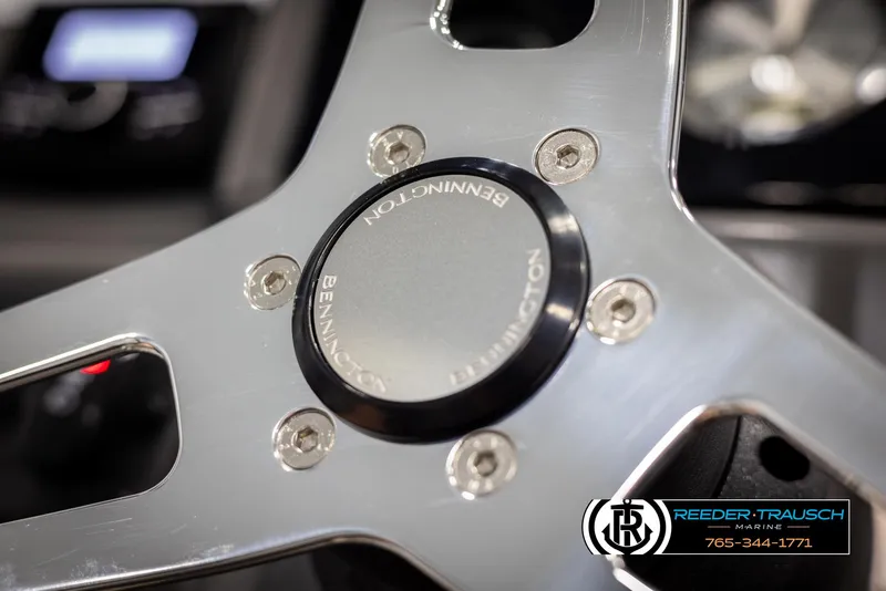 Slide: The Image of Close-up of 2025 Bennington 21 SLSE steering wheel with logo and metallic finish. - 28