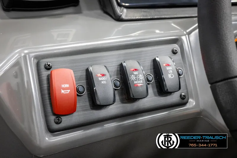 Slide: The Image of Control panel of 2025 Bennington 21 SLSE boat with switches for horn, radio, and lights. - 29