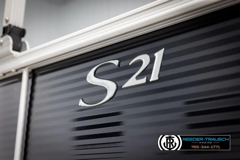 Slide: The Image of 2025 Bennington 21 SLSE boat detail with S21 emblem, Reeder-Trausch Marine branding. - 45