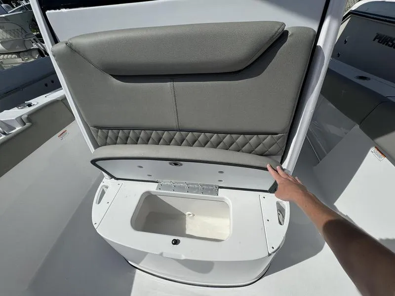 Slide: The Image of 2025 Sportsman Heritage 231 boat seat with storage compartment open. - 13