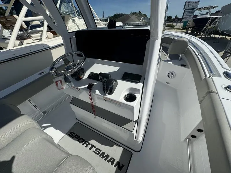 Slide: The Image of 2025 Sportsman Heritage 231 boat interior with steering console and seating. - 17