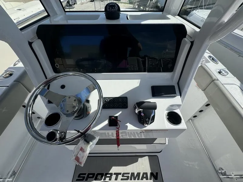 Slide: The Image of 2025 Sportsman Heritage 231 boat dashboard with steering wheel and controls. - 18