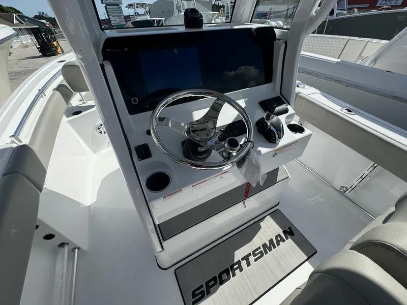 Slide: The Image of 2025 Sportsman Heritage 231 boat console with steering wheel and modern controls. - 19