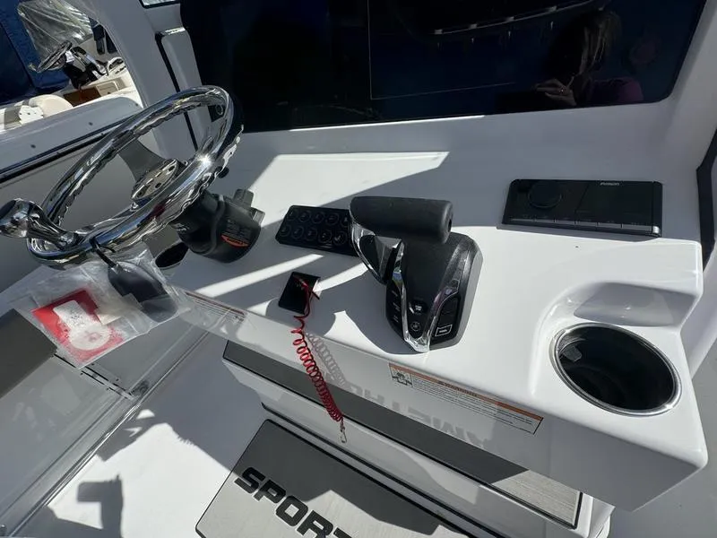 Slide: The Image of 2025 Sportsman Heritage 231 boat console with steering wheel and controls. - 20