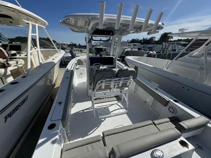 Slide: The Image of 2025 Sportsman Heritage 231 boat with seating and console, docked among other boats. - 22