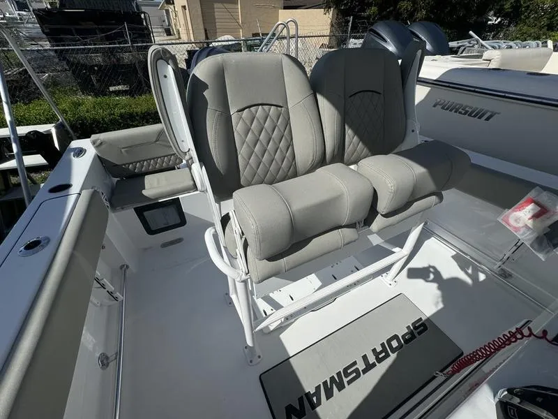 Slide: The Image of 2025 Sportsman Heritage 231 boat with cushioned seating and modern design. - 23