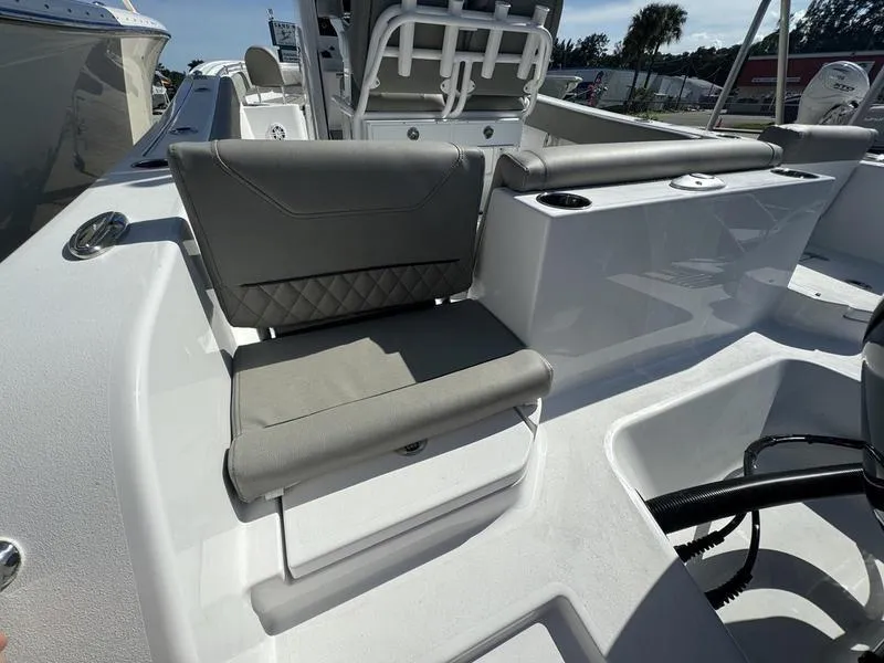Slide: The Image of 2025 Sportsman Heritage 231 boat interior with cushioned seating and cup holders. - 31