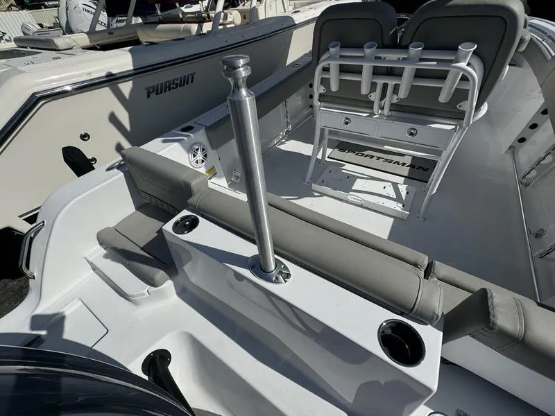 Slide: The Image of 2025 Sportsman Heritage 231 boat interior with seating and rod holders. - 32
