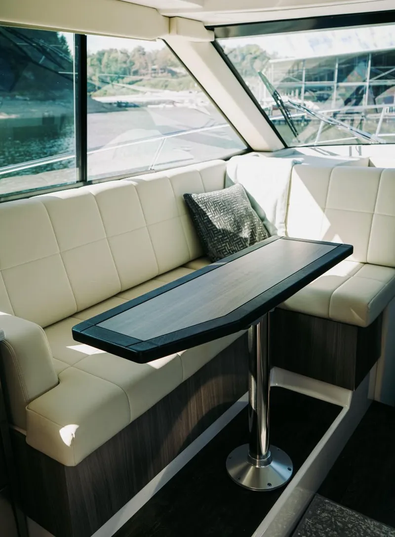 Slide: The Image of Interior of 2021 Regal 38 Grande Coupe with elegant seating and table. - 10