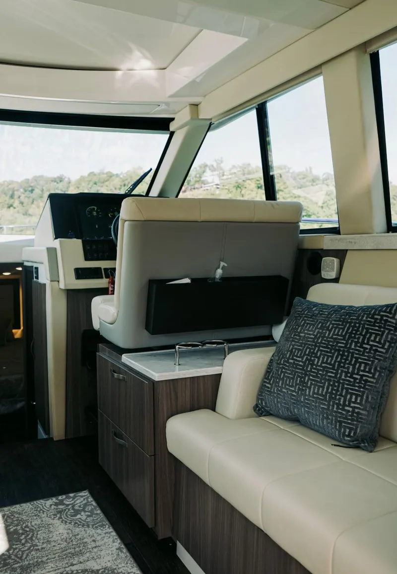 Slide: The Image of Interior of 2021 Regal 38 Grande Coupe yacht with modern seating and helm. - 11