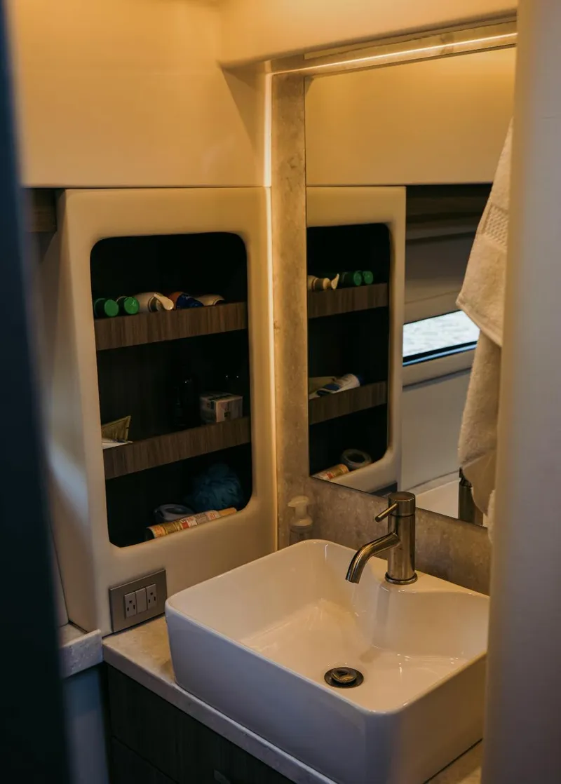 Slide: The Image of Bathroom interior of 2021 Regal 38 Grande Coupe with modern sink and storage shelves. - 15
