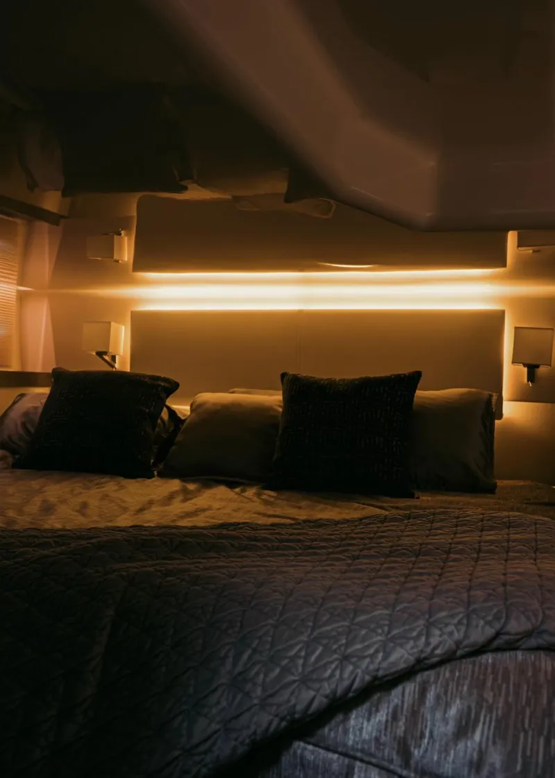 Slide: The Image of Luxurious bedroom interior of 2021 Regal 38 Grande Coupe yacht with ambient lighting. - 16