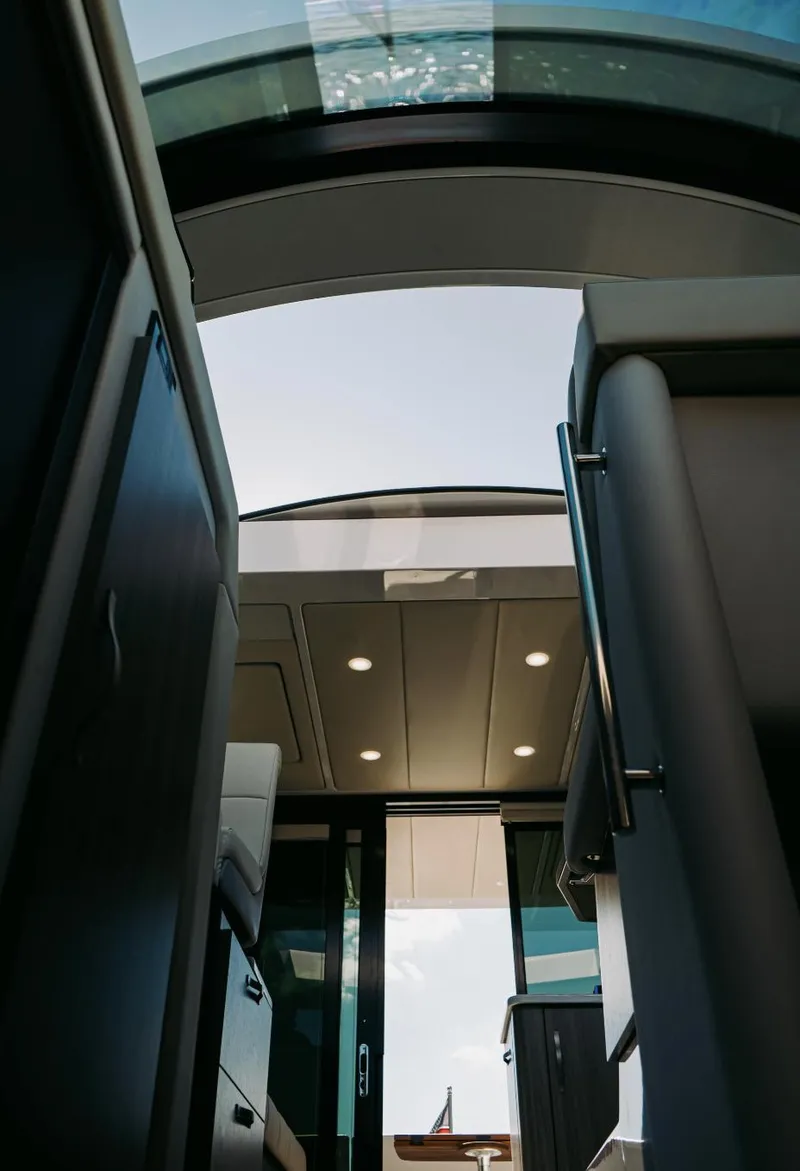 Slide: The Image of Interior view of 2021 Regal 38 Grande Coupe yacht with open sunroof. - 17