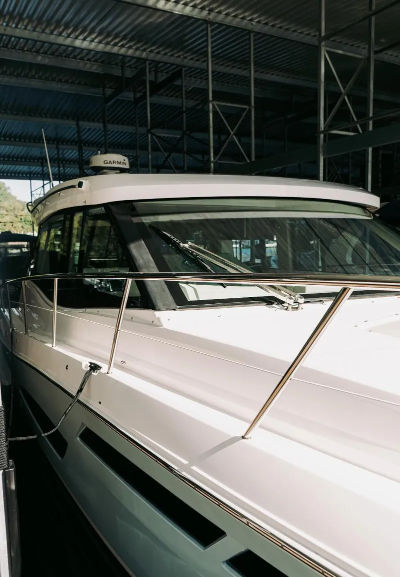 Slide: The Image of 2021 Regal 38 Grande Coupe yacht in a marina, showcasing sleek design and modern features. - 23