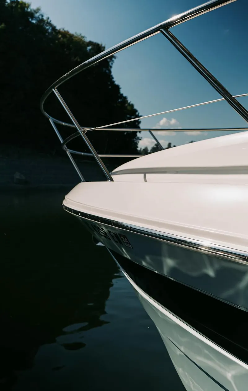 Slide: The Image of 2021 Regal 38 Grande Coupe boat, sleek design, close-up view, sunny day on water. - 26