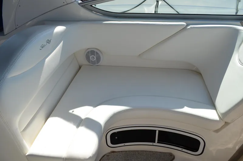 Slide: The Image of 2004 Sea Ray 280 Sundancer interior seating with white upholstery and speaker. - 16