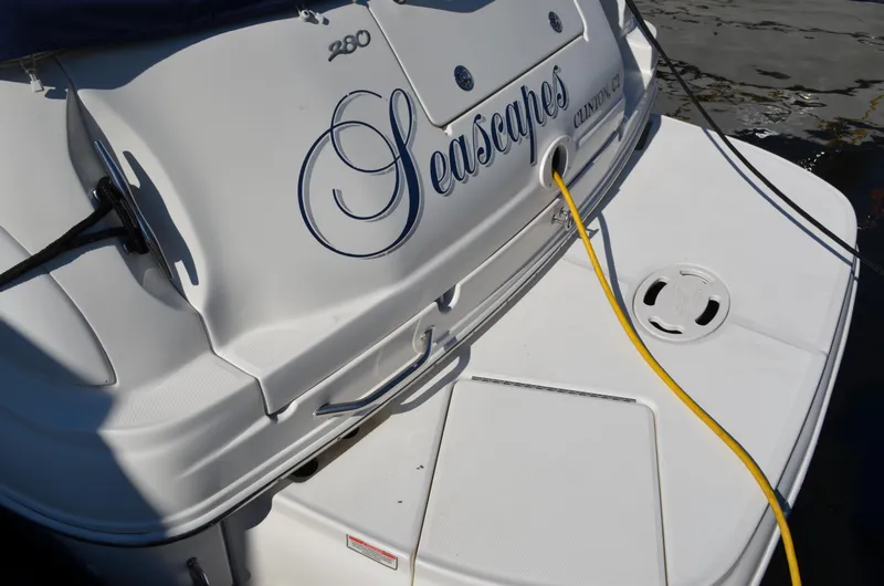 Slide: The Image of 2004 Sea Ray 280 Sundancer boat stern with docked power cable. - 2