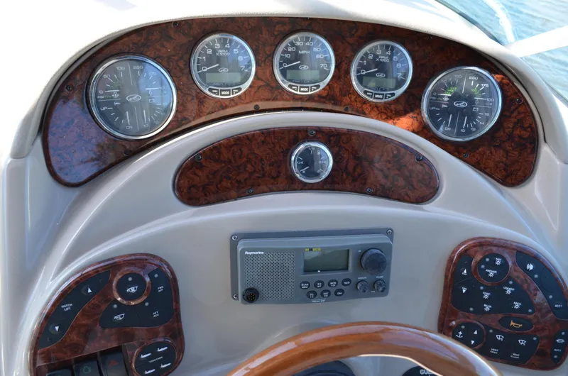 Slide: The Image of Dashboard of a 2004 Sea Ray 280 Sundancer boat with gauges and controls. - 22