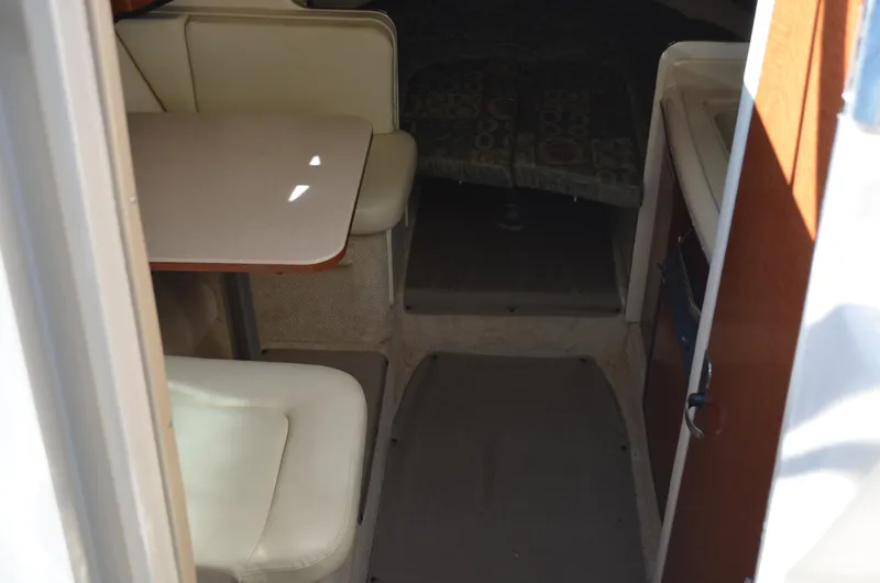 Slide: The Image of Interior view of 2004 Sea Ray 280 Sundancer cabin with seating and table. - 27