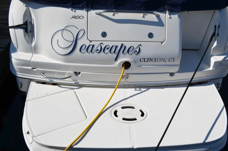 Slide: The Image of 2004 Sea Ray 280 Sundancer boat stern with "Seascapes" name, docked in Clinton, CT. - 3