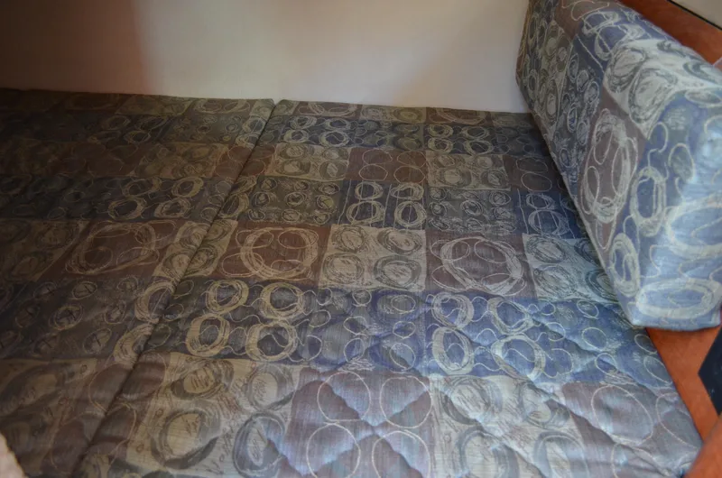 Slide: The Image of Interior cabin bed of 2004 Sea Ray 280 Sundancer with patterned upholstery. - 36