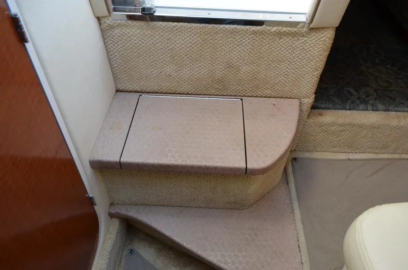 Slide: The Image of Interior steps of a 2004 Sea Ray 280 Sundancer boat, featuring beige carpeting. - 37