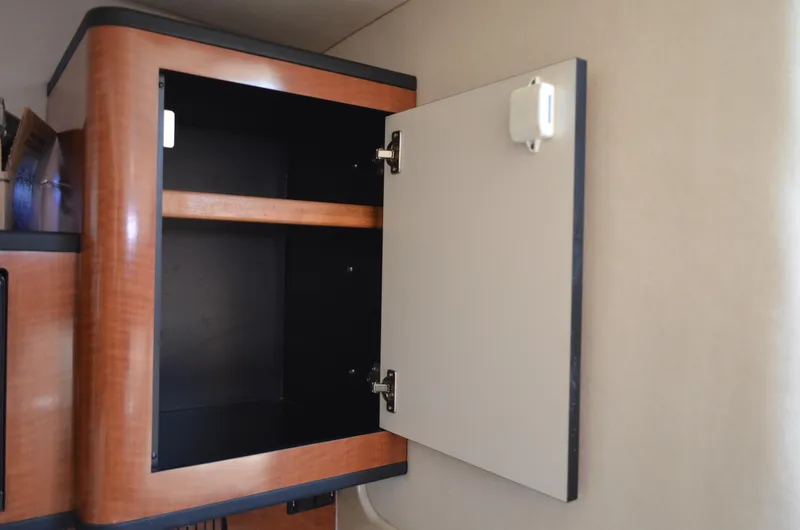 Slide: The Image of Open wooden cabinet inside 2004 Sea Ray 280 Sundancer boat interior. - 40