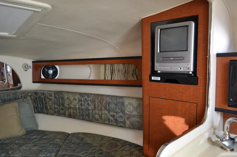 Slide: The Image of 2004 Sea Ray 280 Sundancer cabin interior with TV and seating area. - 41