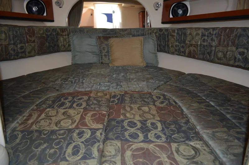 Slide: The Image of 2004 Sea Ray 280 Sundancer cabin interior with patterned bedding and cushions. - 42