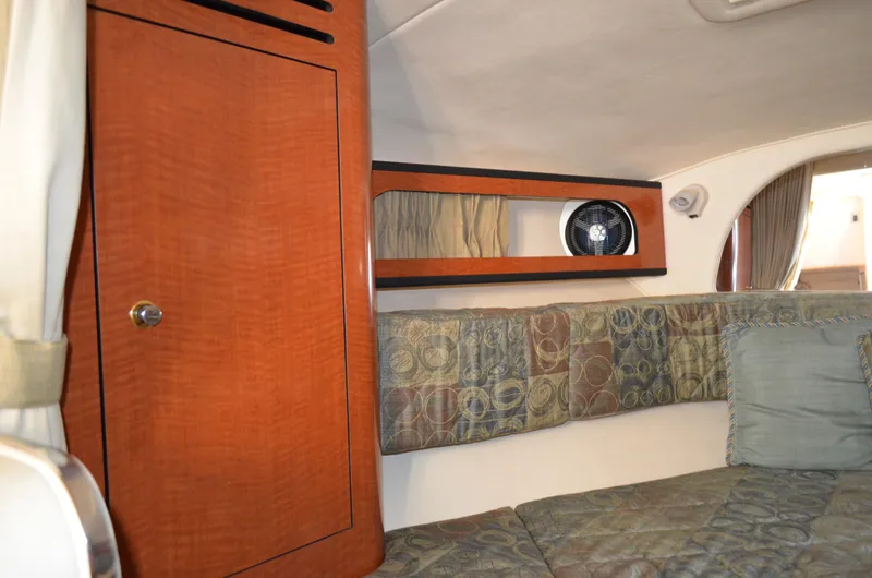 Slide: The Image of Interior of 2004 Sea Ray 280 Sundancer with wood cabinet and patterned upholstery. - 46